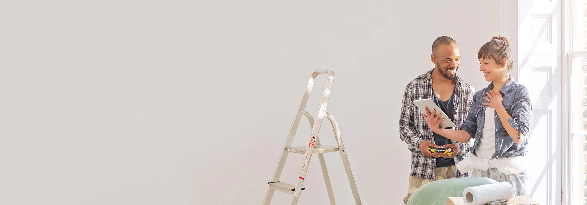 A couple getting ready to paint a room in their new home.