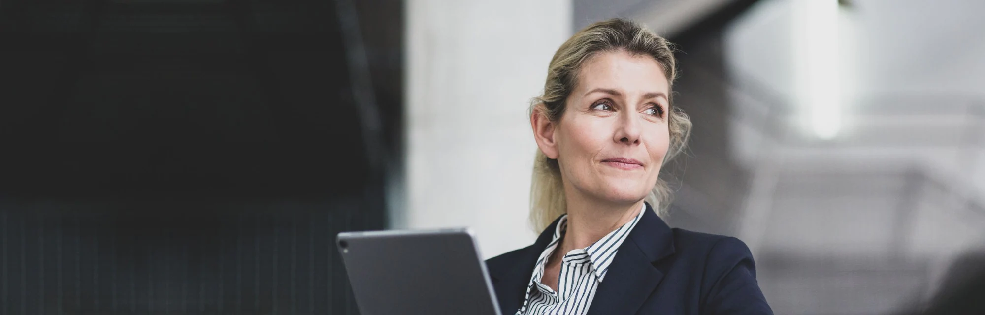 Woman using her tablet to sign on to Weiming Trust SmartBanking for Business